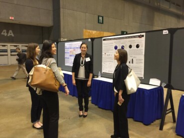 Liz, Susan, and Amanda visit Jessica at her poster to ask the "hard" questions.
